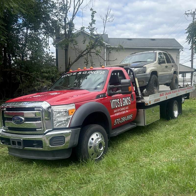 SUV being towed by Vitos and Ginos tow truck
